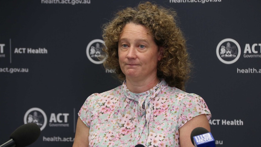 Kerryn Coleman speaks in front of ACT Government backdrop.