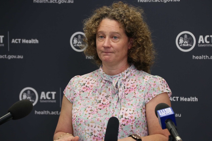 Kerryn Coleman speaks in front of ACT Government backdrop.