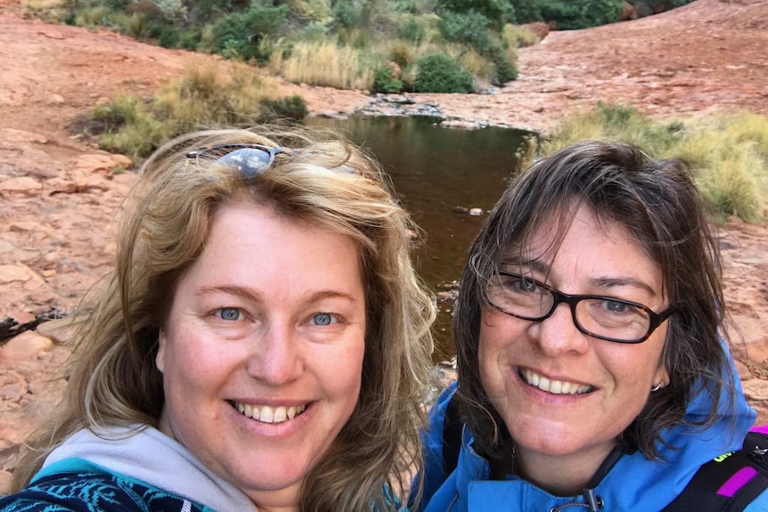 Two women, Glenda and Jennifer, smile at the camera at a public function.