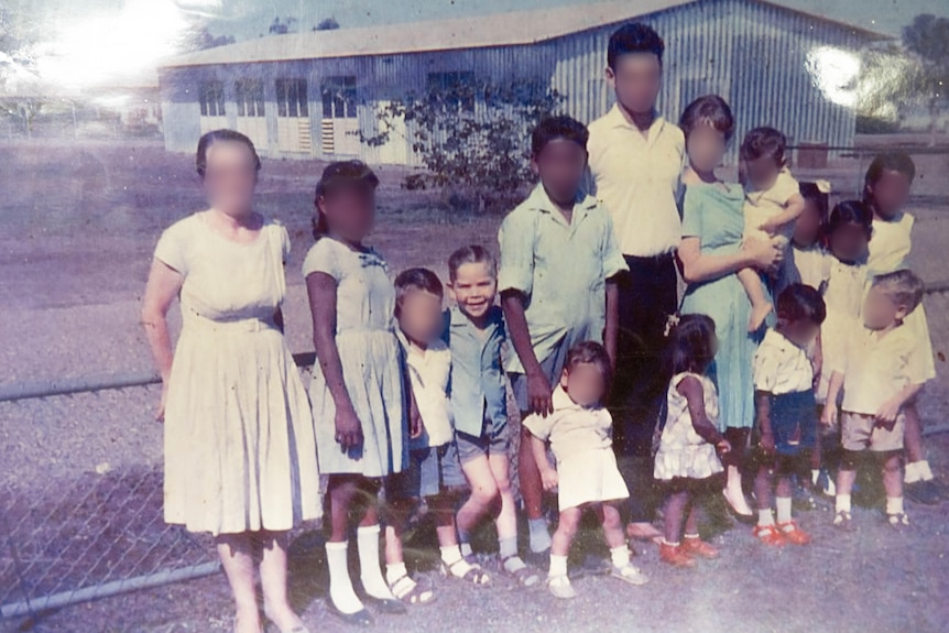 An old photo showing a group of kids at a children's home in Darwin, most with their faces blurred.