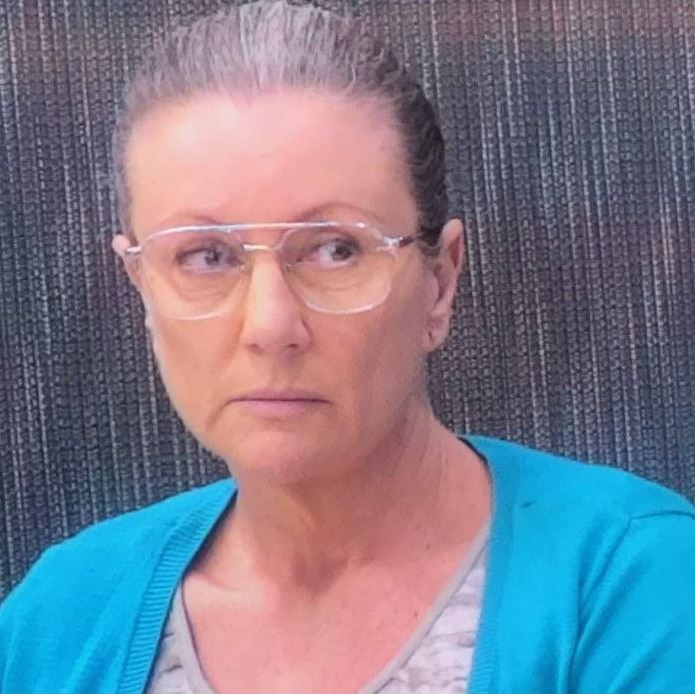 woman in blue wearing glasses