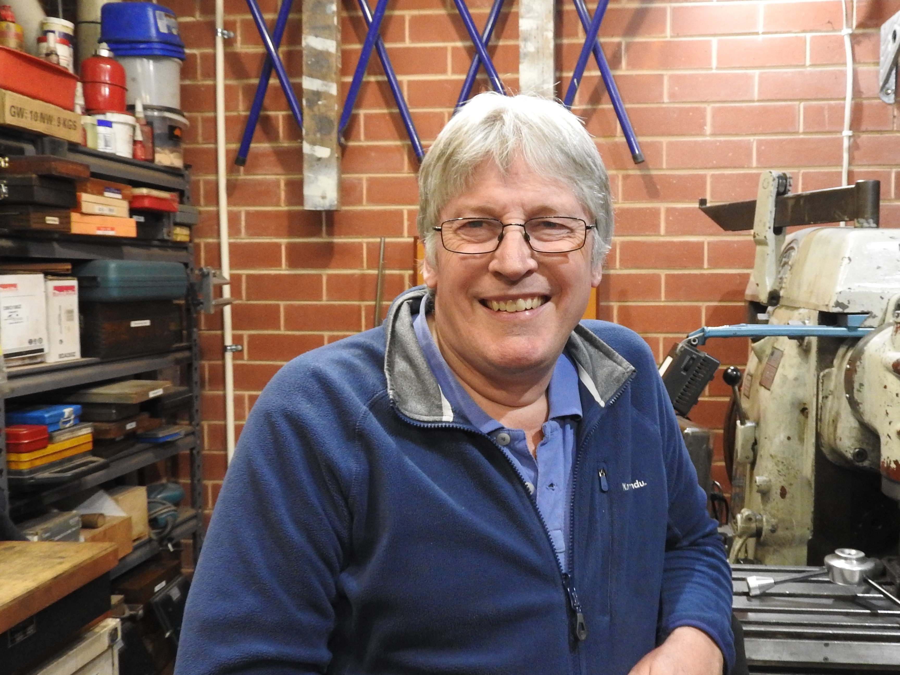 Michael in his shed workshop, smiling
