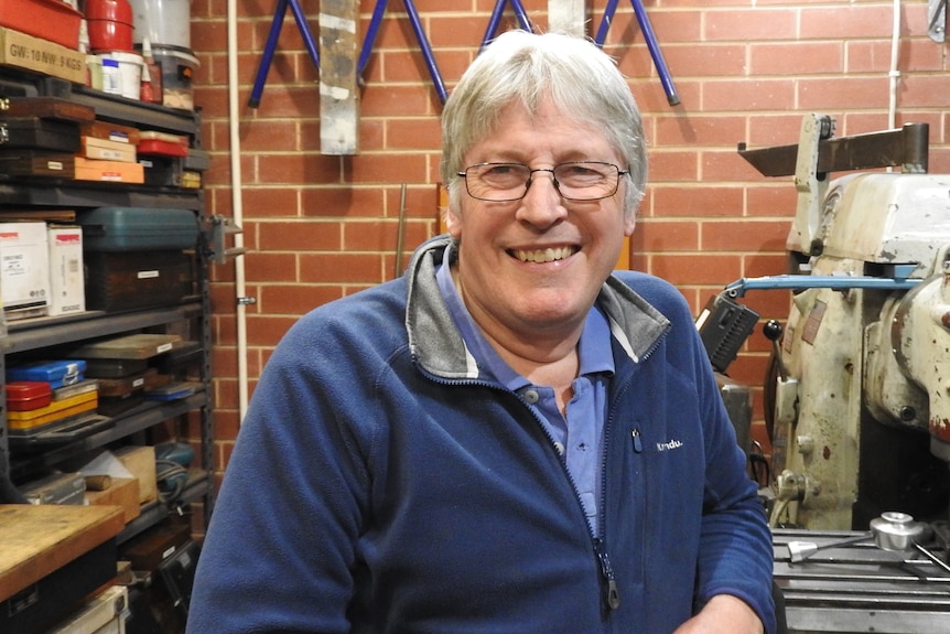 Michael in his shed workshop, smiling
