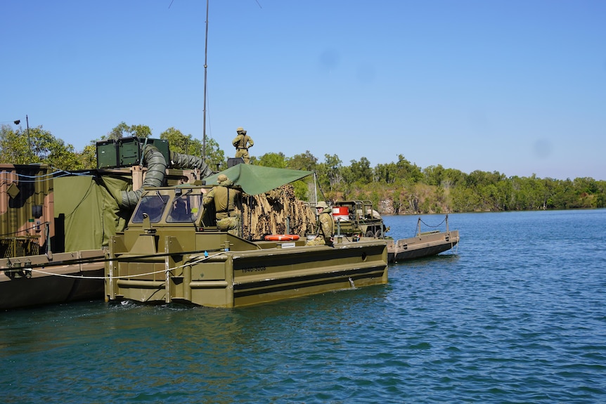 A wide shot of floating command post surrounded by water. 