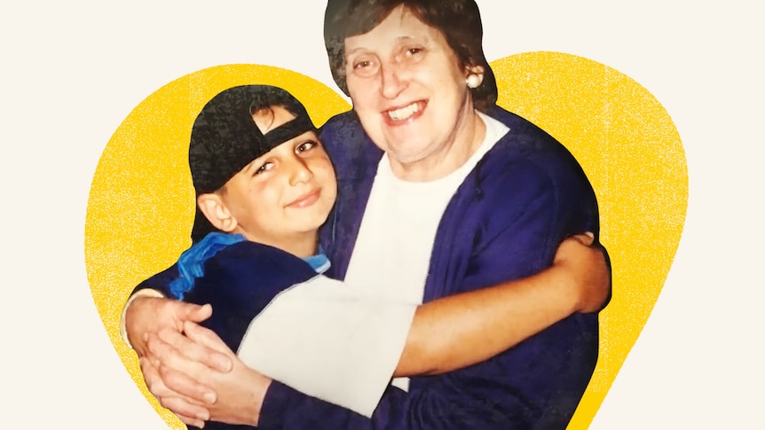 A young boy wears a black baseball cap backward and hugs an older smiling woman wearing a blue and and white top.  