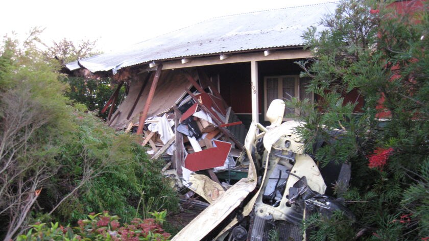 The car had its roof sheared off when it careened into the verandah of this house