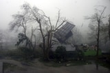 The roof flies off a house as super typhoon Megi hits the Philippines