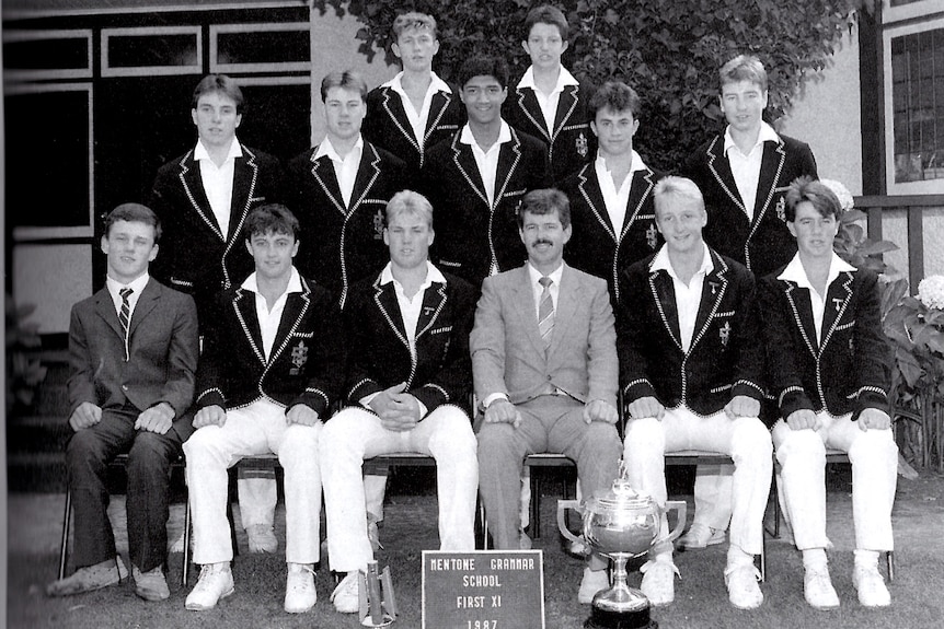 A black and white team photo of a cricket team.
