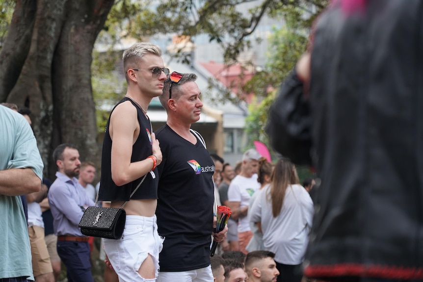 Two men stand together at vigil on 010324 in darlinghurst to honour the lives of Jesse Baird and Luke Davies 