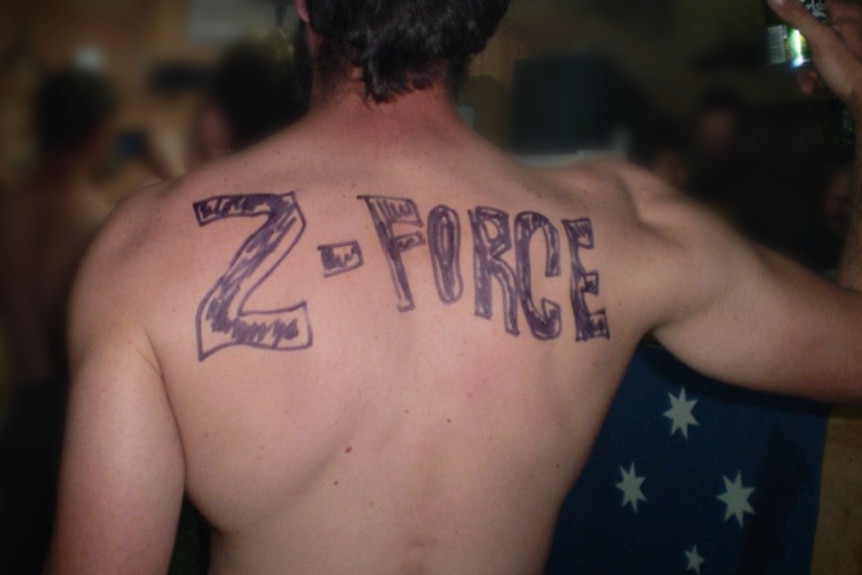 A shirtless man with Z-Force written in texta across his back.