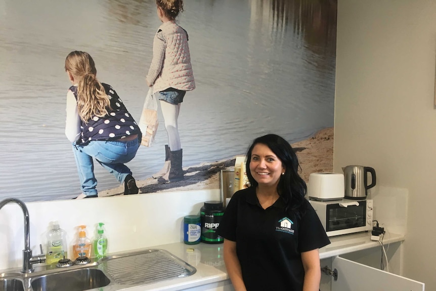 Rylee Brown, support worker at the cottage standing in the kitchen