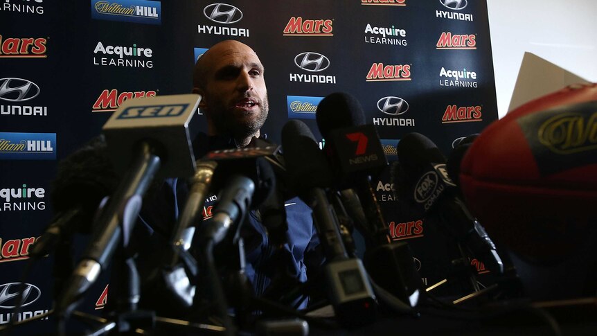 Curtain drawn ... Chris Judd speaks to the media at Princes Park after announcing his retirement