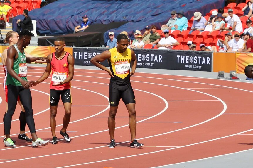 Theo shakes the hands of the fellow sprinters after crossing the finish line.