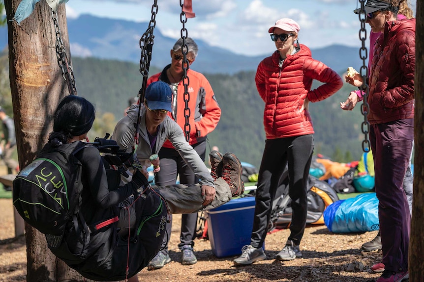 Women in puffy jackets stand around