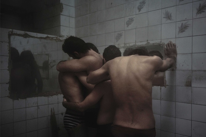 Hoda Afshar's photographic work Behold, a group of gay men embrace in a bathhouse