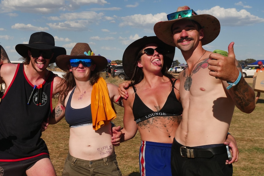 a photo of a group, all wearing akubra hats and women wearing sports bras