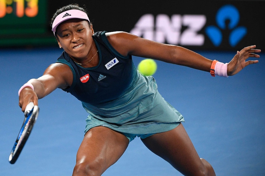 Naomi Osaka stretches for a forehand return.