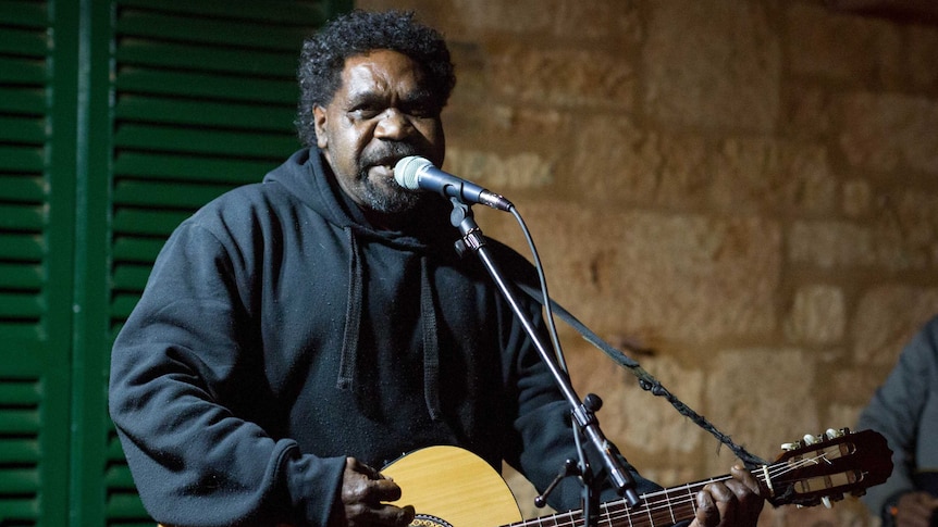 Aboriginal elder James Minning playing guitar during a concert in Coolgardie with Desert Stars.
