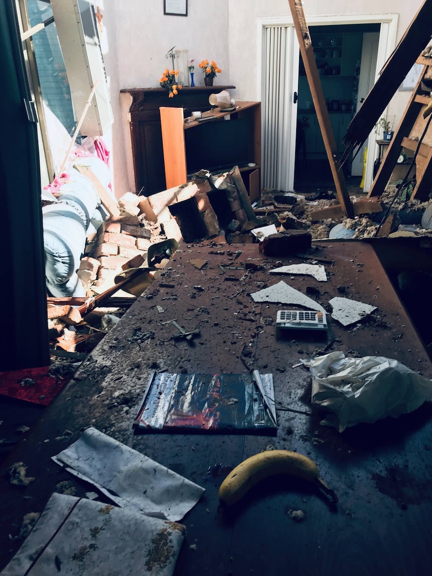 photo of house interior strewn with debris