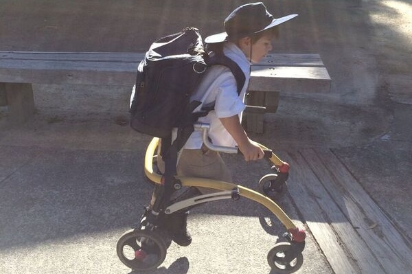 Max at school using his walking frame.