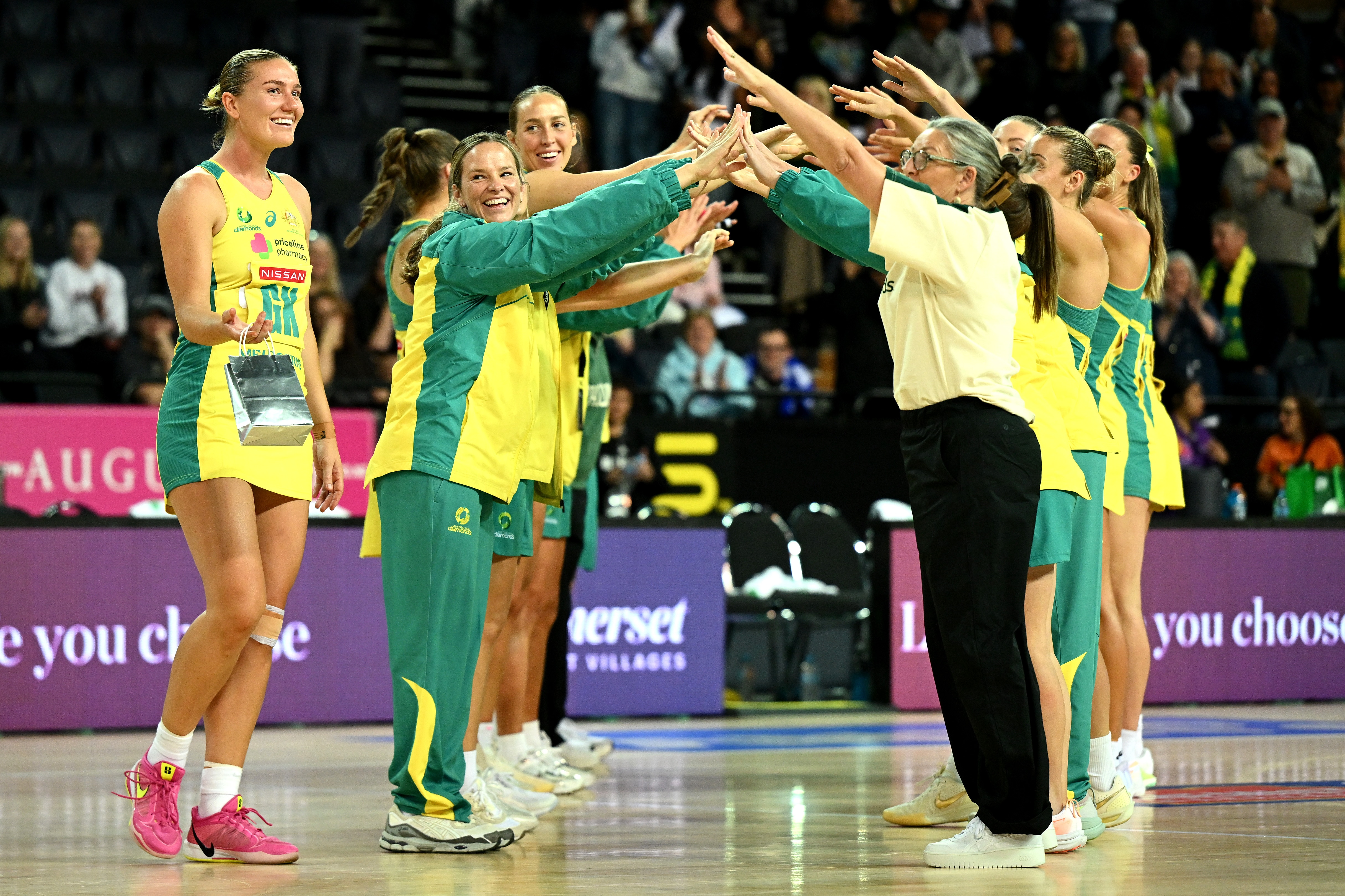 Players and staff form a guard of honour for a milestone player