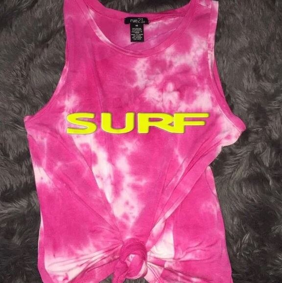 Pink tie-dyed tank top with yellow letters that spell SURF.