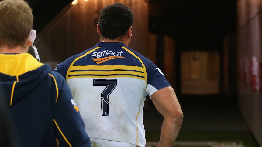 Night over ... George Smith walks up the tunnel after leaving the field with a knee injury