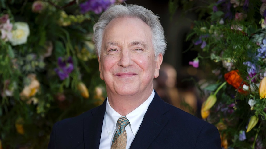 Alan Rickman smiles.