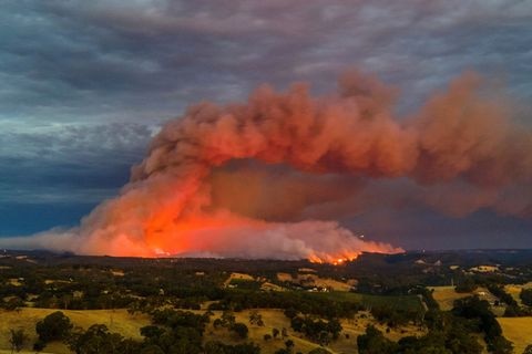 Red smoke and fire over land