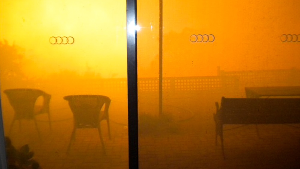 An orange smoke cloud fills Paula Tose's front window.