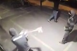 Men use an axe to break into motorcycle store