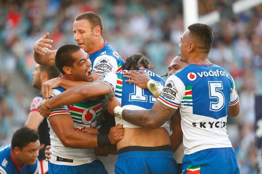 Warriors players celebrate after scoring a try against the Roosters at the SFS.
