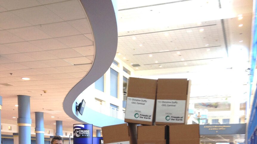 Man standing next to a stack of boxes