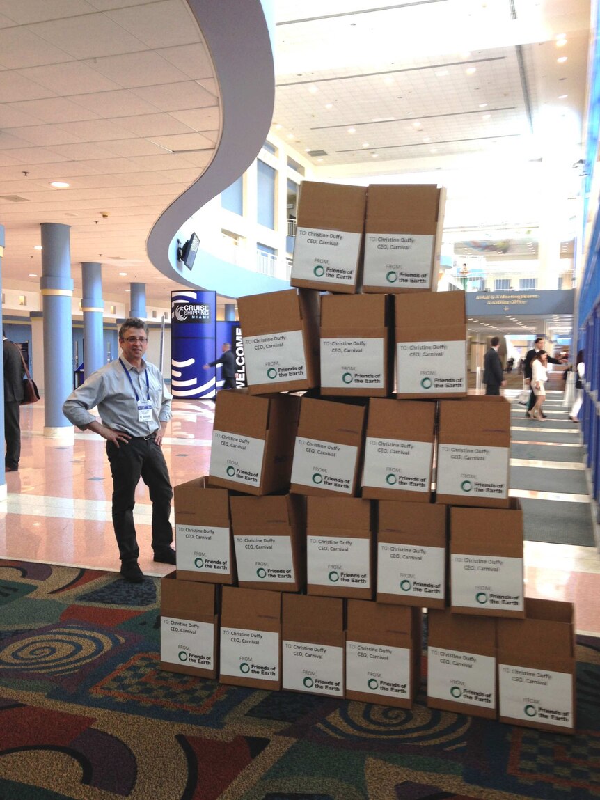 Man standing next to a stack of boxes