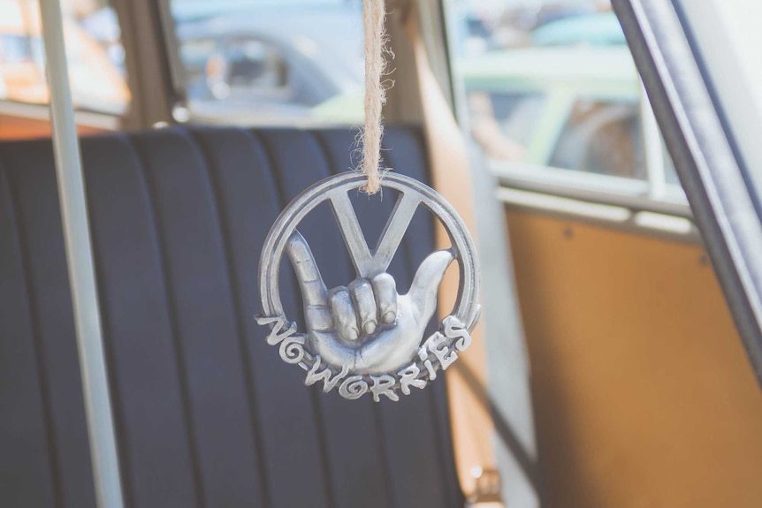 No worries pendant hanging in a car