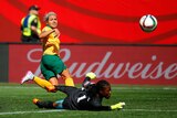 Australia's Kyah Simon scores past Nigerian keeper Precious Dede at the Women's World Cup.