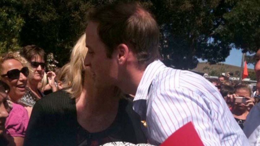 Prince William gets a kiss from one of the locals at Whittlesea