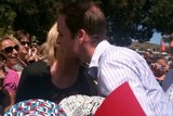 Prince William gets a kiss from one of the locals at Whittlesea