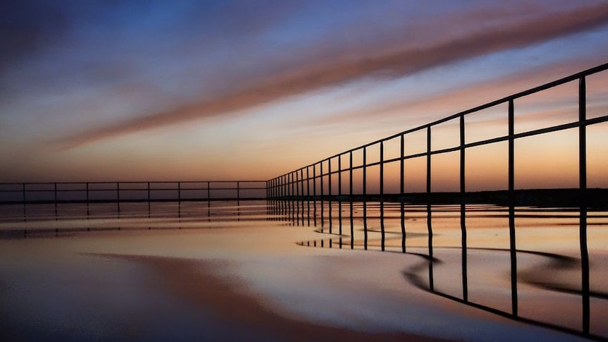 Early morning light reflects on the Towradgi ocean pool near Wollongong.