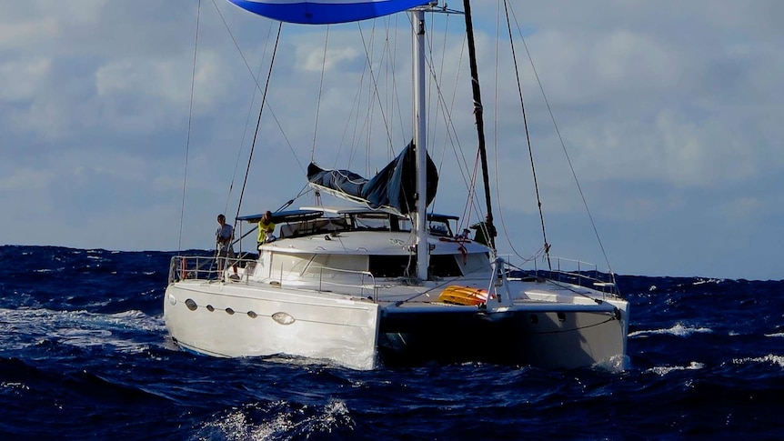 The sailing catamaran 'Vivo' cuts through open water between the Galapagos Islands and French Polynesia.