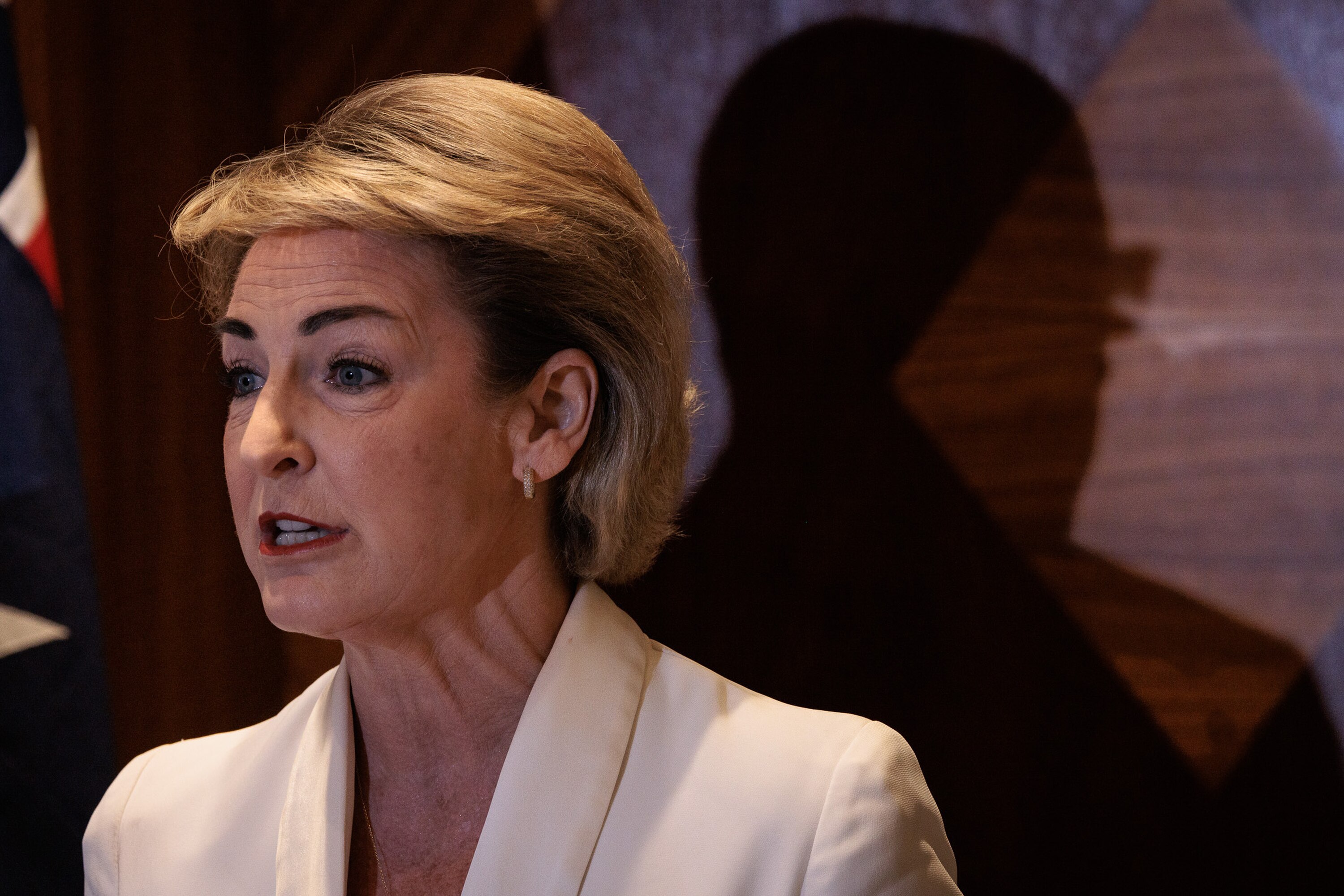 Michaelia Cash in front of a shadow of Peter Dutton. 