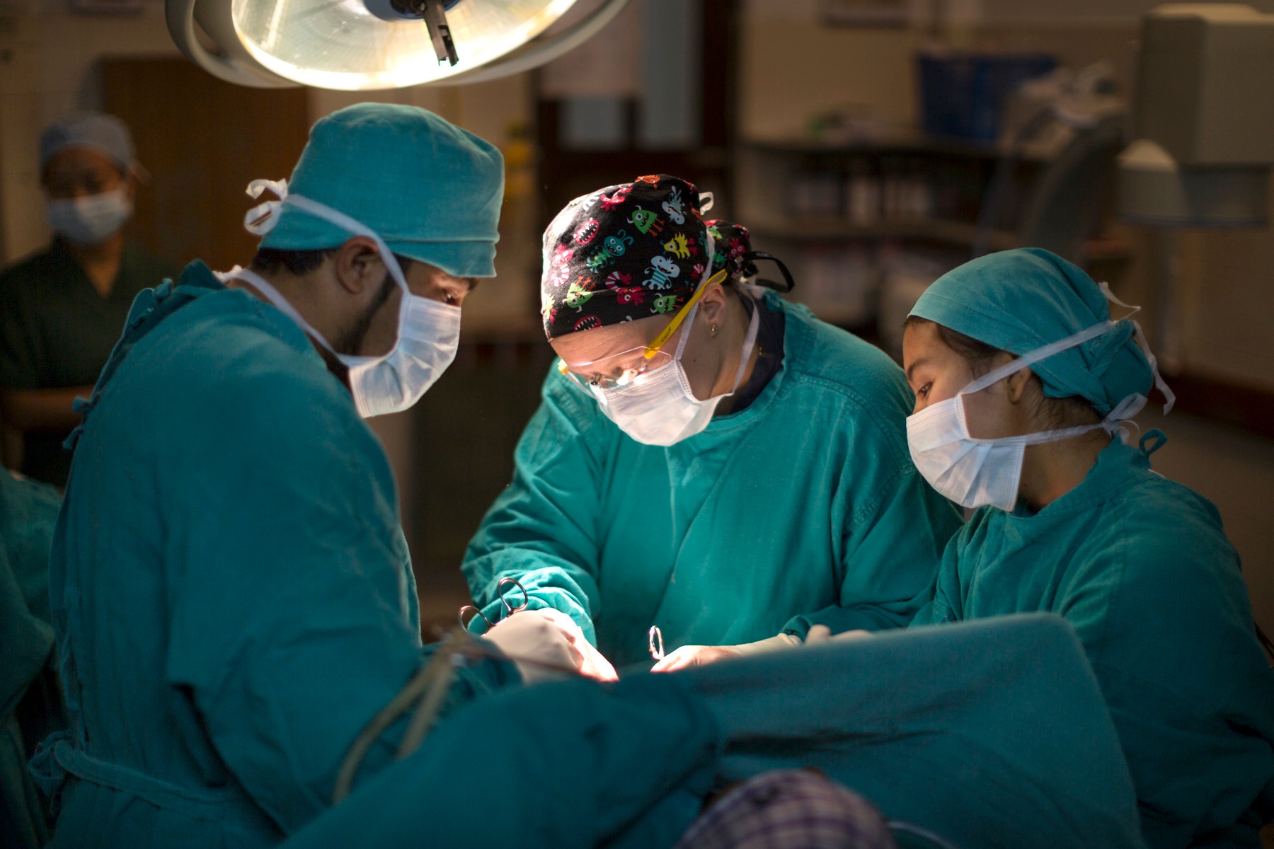 A surgeon operates in a theatre. 