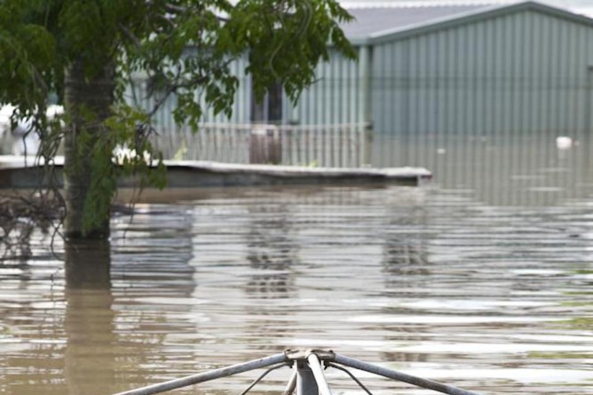 Floodwaters engulf a backyard clothesline