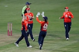 The bowler and wicketkeeper run in to exchange high-five after a wicket in the Women's Ashes.