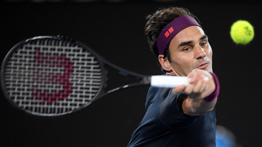 Roger Federer swings a forehand at the tennis ball during his Australian Open clash with Filip Krajinovic.