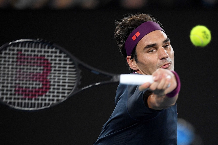 Roger Federer swings a forehand at the tennis ball during his Australian Open clash with Filip Krajinovic.