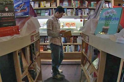 A man reading a book in a bookshop