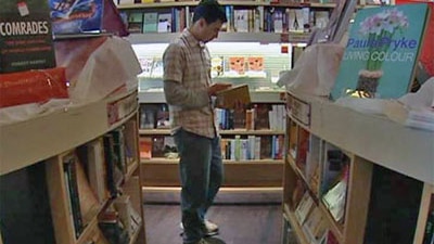 A man reading a book in a bookshop