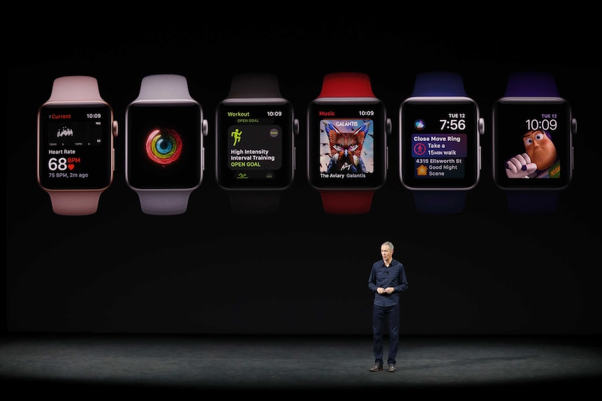 Apple COO, speaks as product images are shown behind him during a launch event