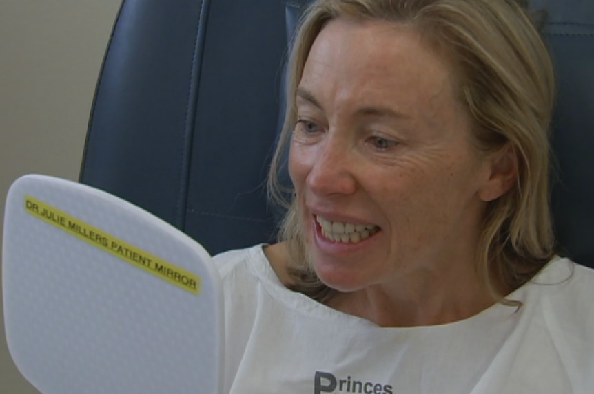 Susie Robinson looks at her smile for the first time after the operation